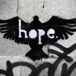 A spray painting of a bird with the word "hope" stencilled out of it.