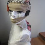 Female manikin with multiple media attached to it.