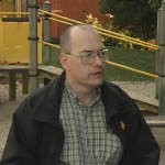 A man in front of a playground.