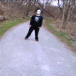 Mysterious masked person standing in a park trail